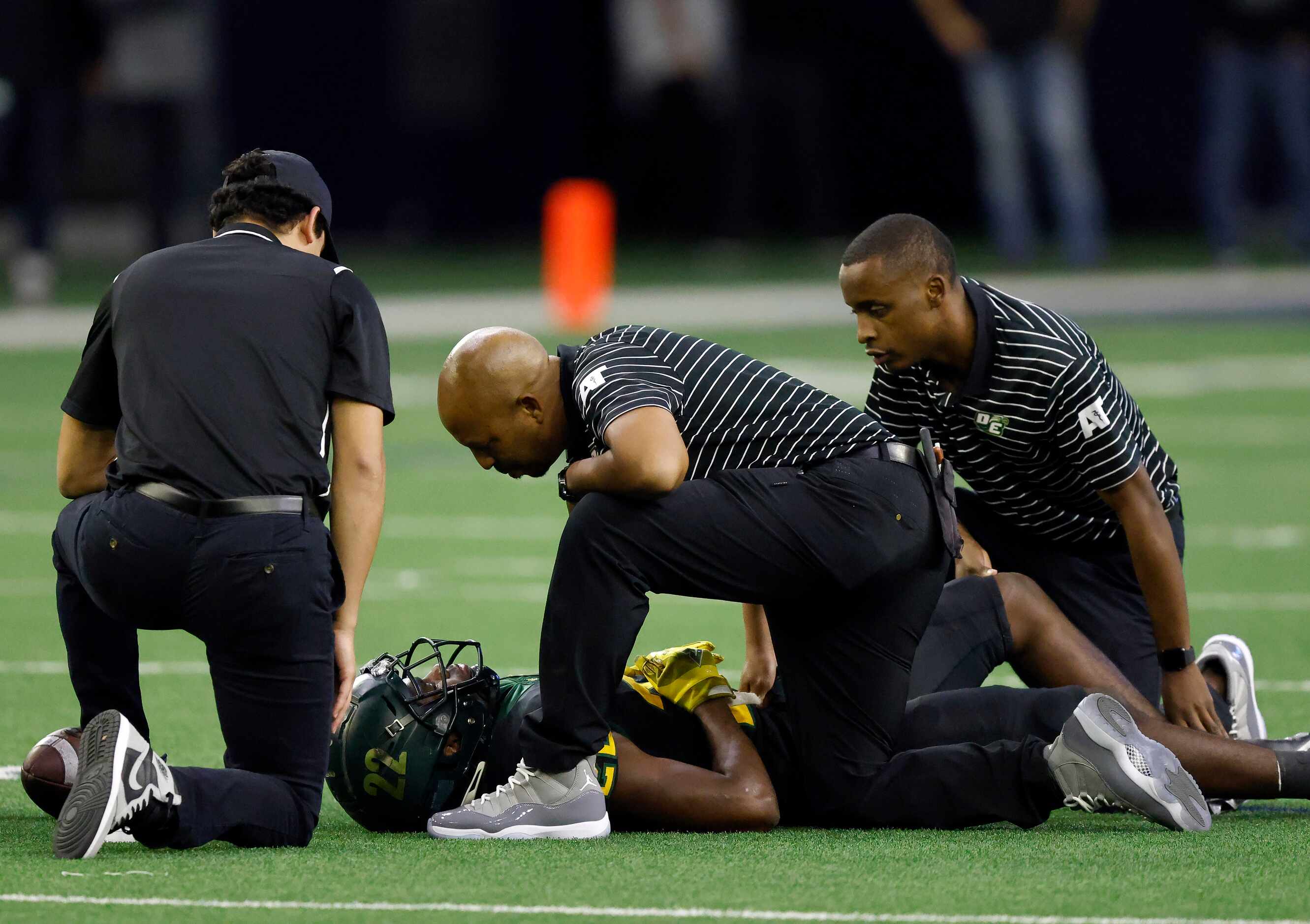 DeSoto running back Deondrae Riden Jr. (22) is attended to by athletic trainers after...