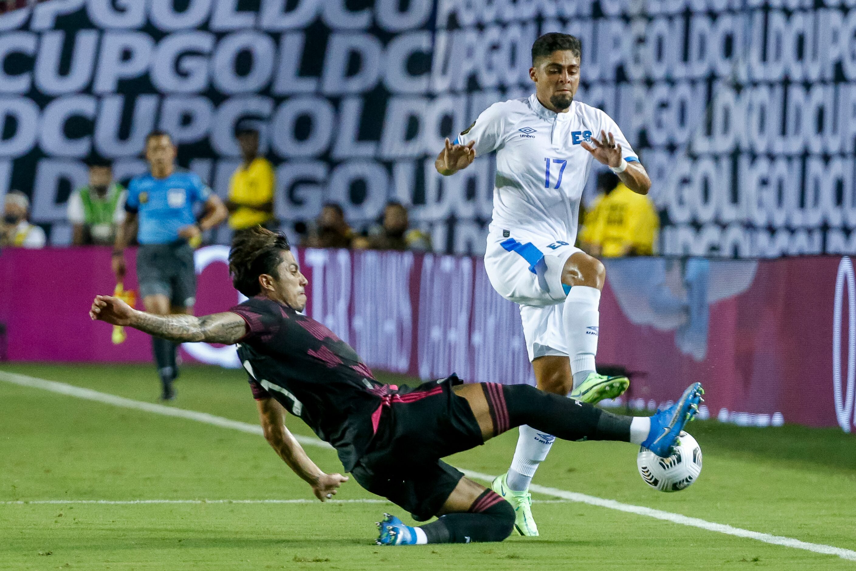 Mexico defender Osvaldo Rodríguez (5) slides into El Salvador midfielder Jairo Henriquez...