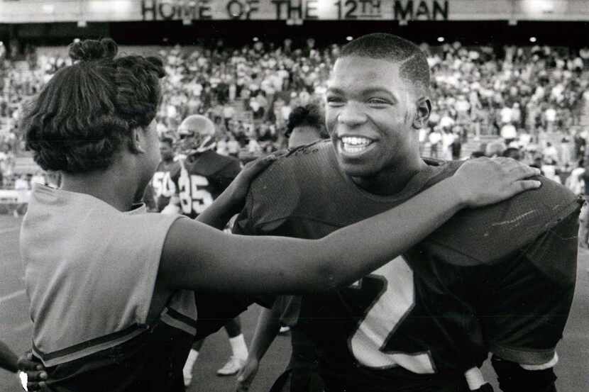 Carter's Gary Edwards, who scored a touchdown and intercepted a pass, is congratulated by a...