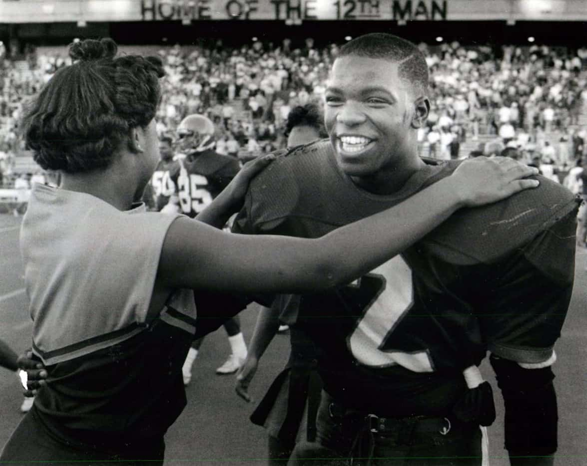 Carter's Gary Edwards, who scored a touchdown and intercepted a pass, is congratulated by a...