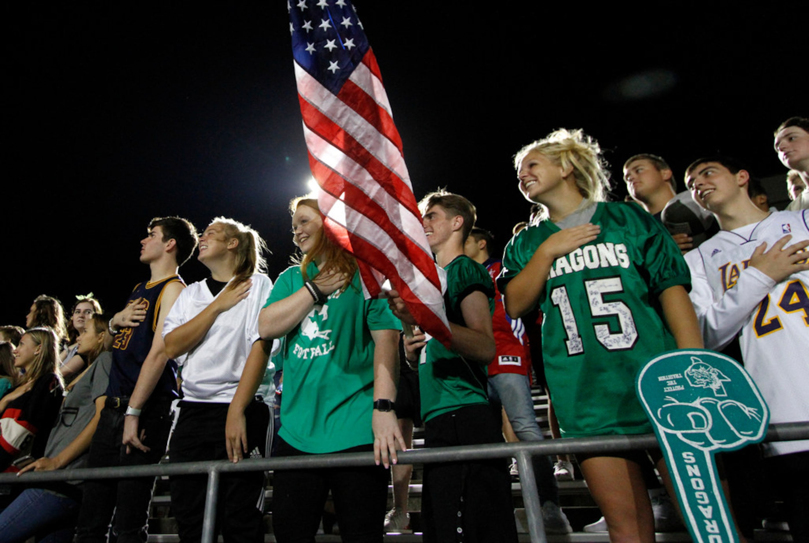 Southlake Carroll fans fill the student section as they pause for the playing of the...