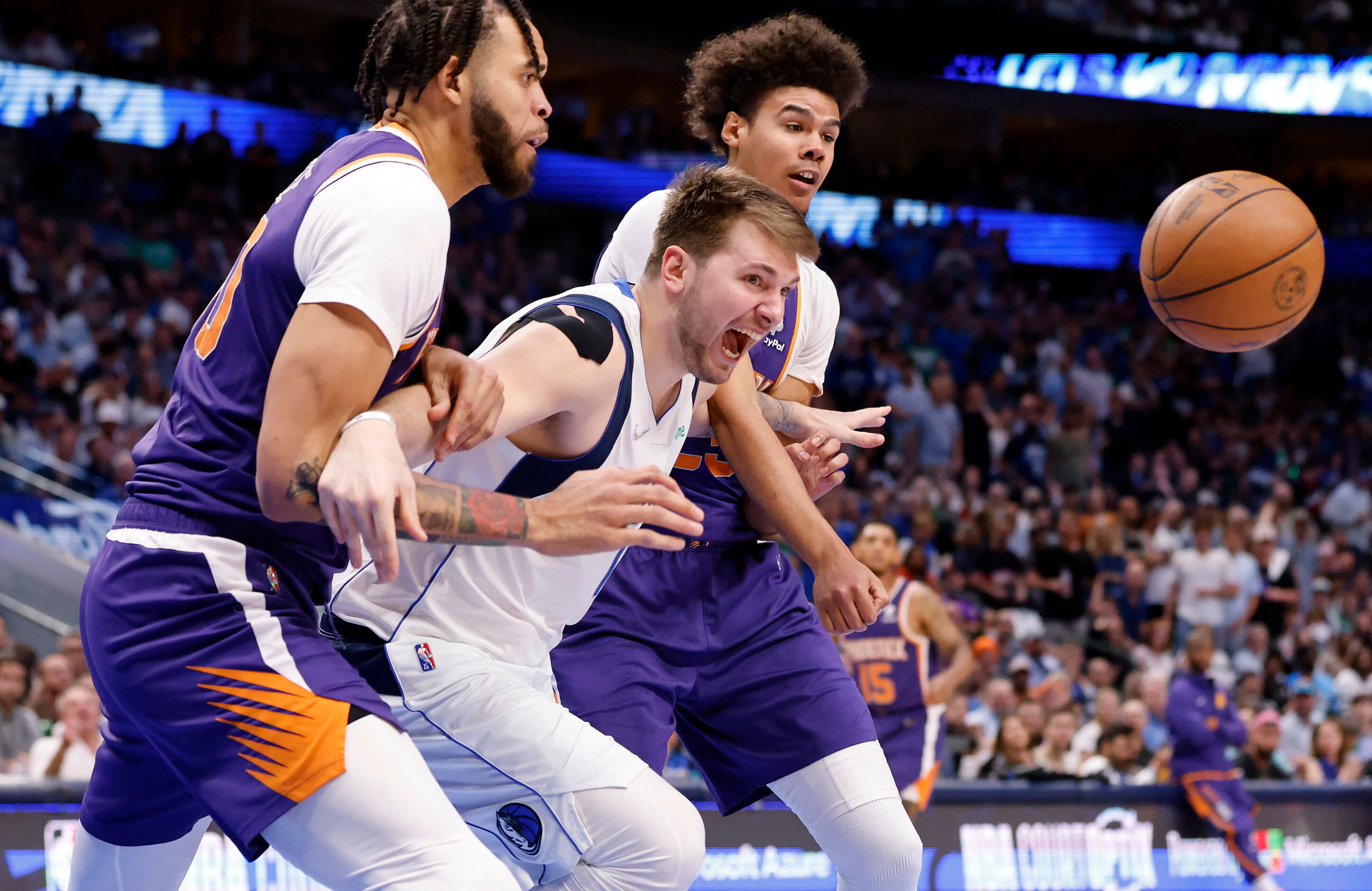 Dallas Mavericks guard Luka Doncic (77) goes up for an offensive rebound and is fouled as he...