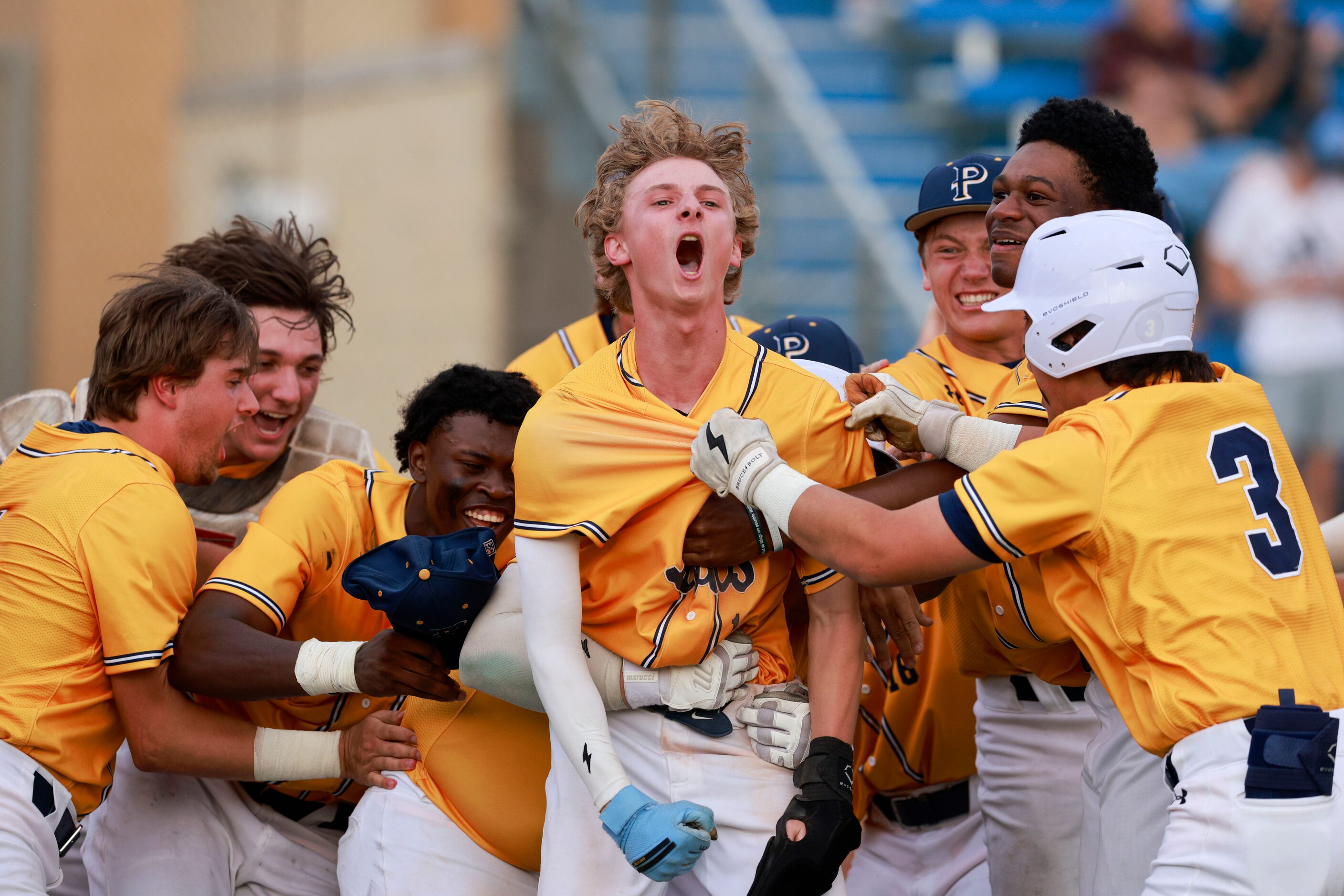 Plano Prestonwood’s Tanner Trout (center) is swarmed by teammates after stealing home in the...