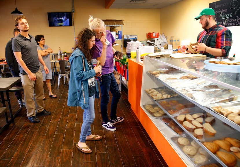 Friends Evan Gordon (center, right) and Zoe Pesce of Dallas pick out pastries.