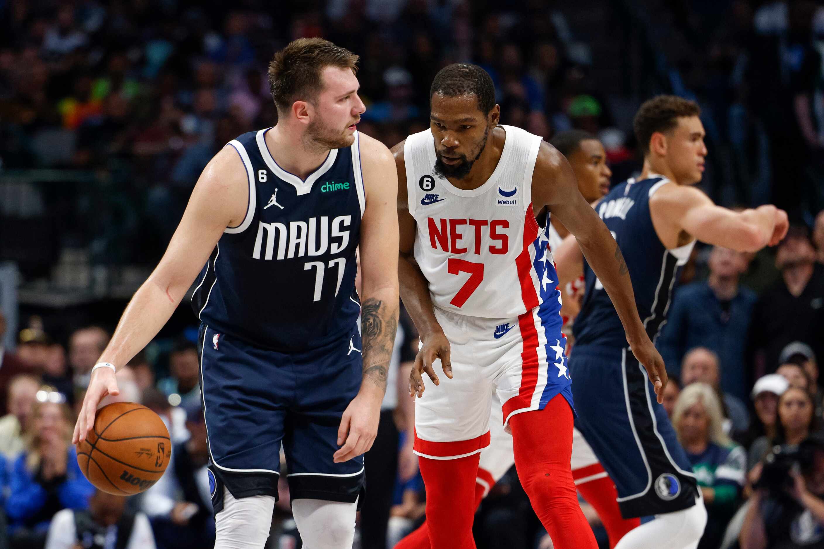 Brooklyn Nets forward Kevin Durant (7) defends against Dallas Mavericks guard Luka Doncic...