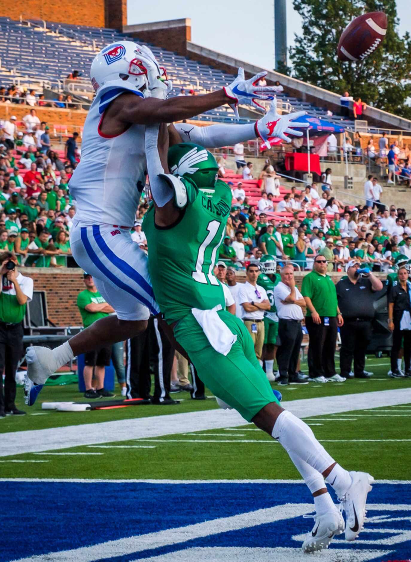 UNT defensive back Cam Johnson (11) breaks up a pass intended for SMU wide receiver James...