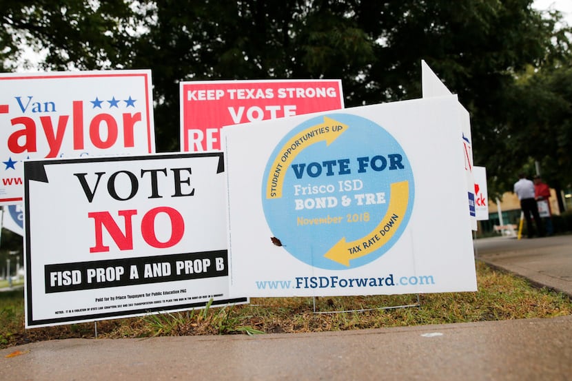 Signs for and against the Frisco ISD Bond & TRE outside a polling station at Collin College...