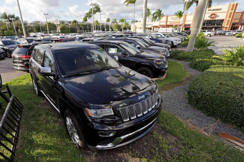 In this Thursday, Nov. 5, 2015, file photo, 2015 Jeep Grand Cherokees appear on display at a...