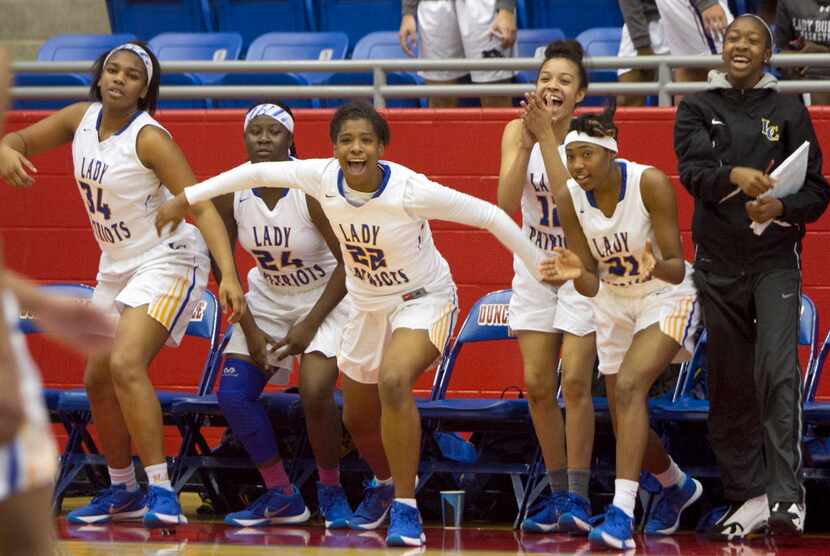 Members of the Garland Lakeview Centennial basketball team erupt following a last second...