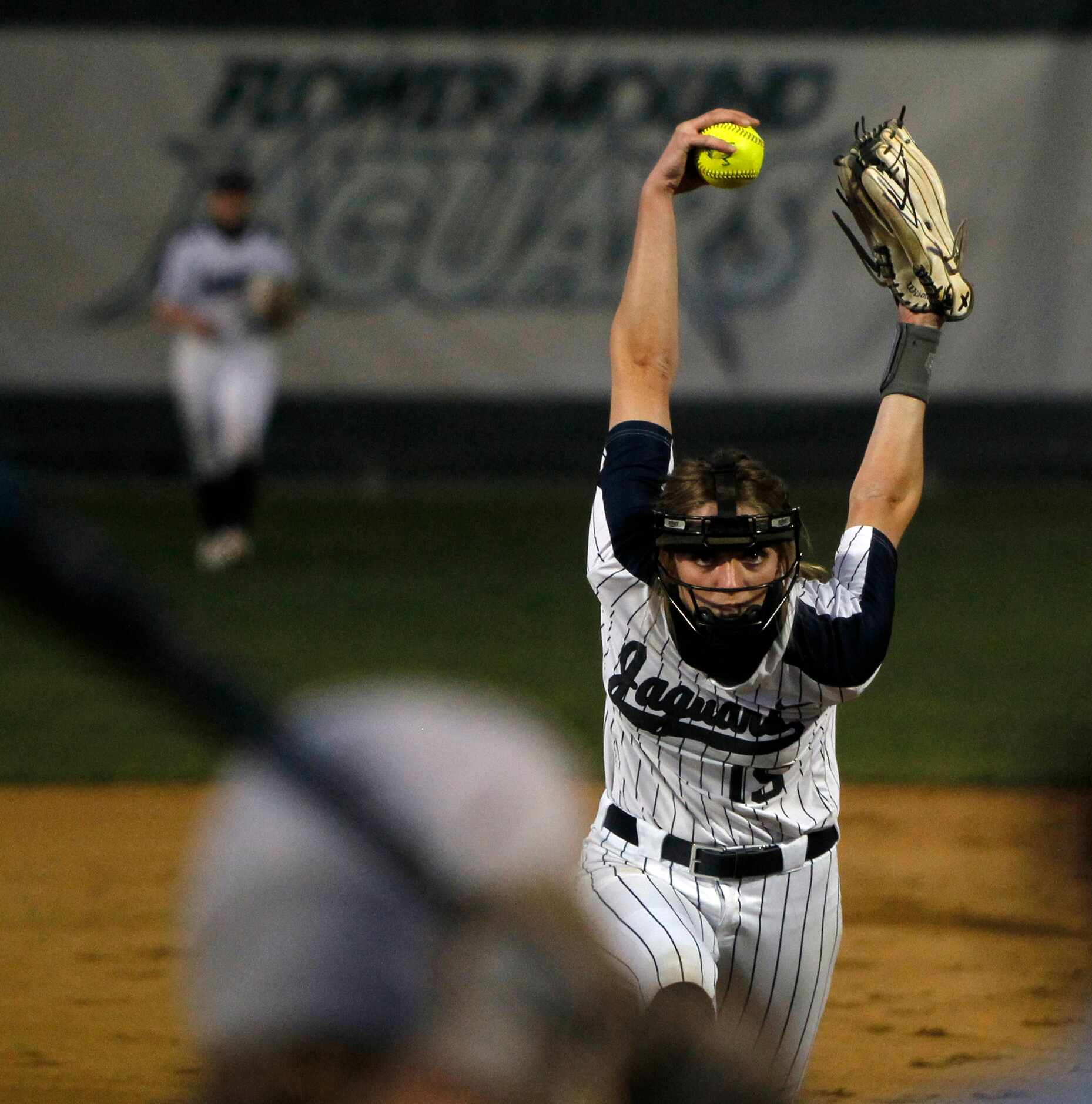 Flower Mound sophomore pitcher Landrie Harris (15) goes through her wind-up before...
