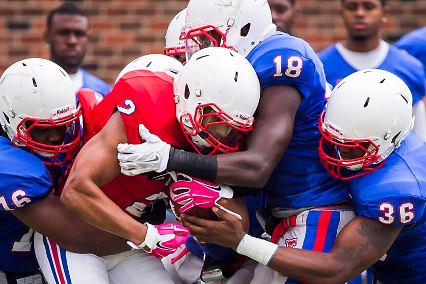 SMU wide receiver Xavier Castille (2) is wrapped up by linebacker Jeremy White (16),...