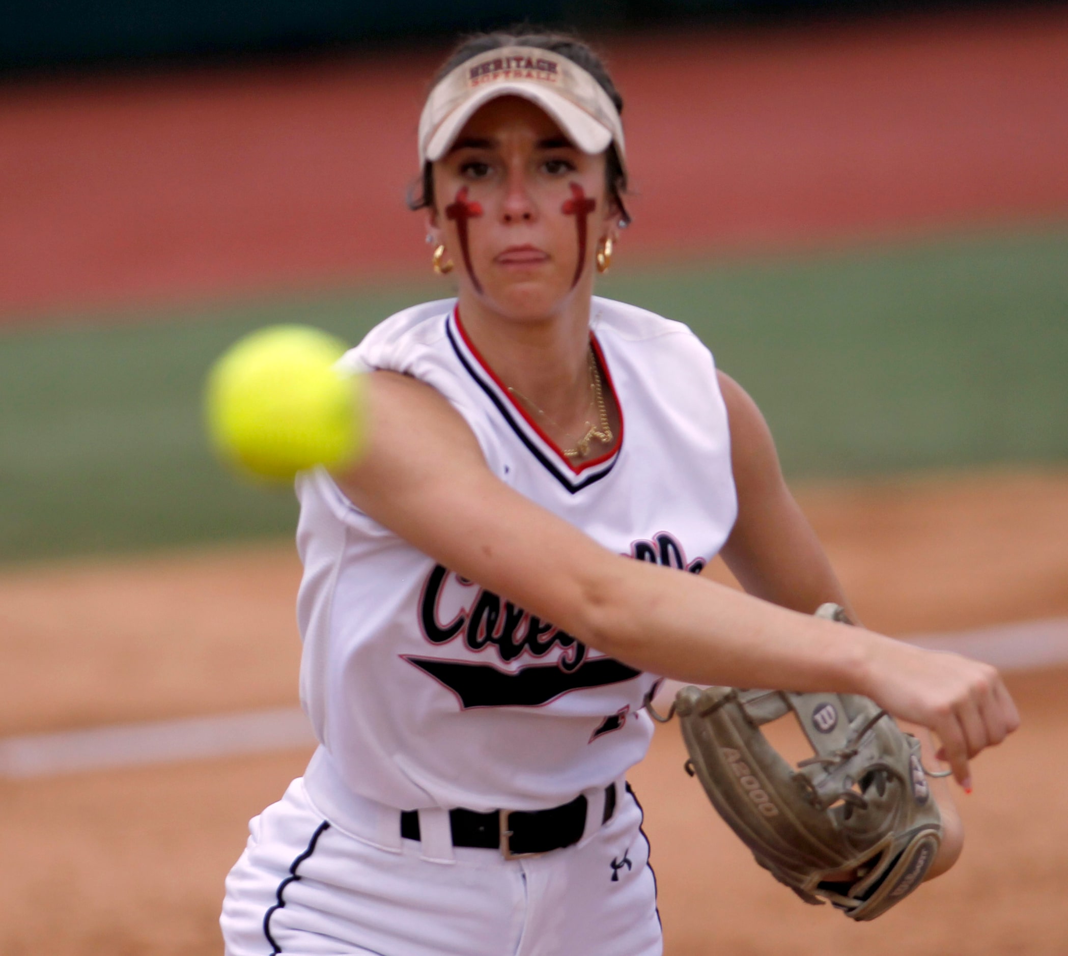 Colleyville Heritage third baseman Graci Green (11) throws out a Comal Canyon batter after...