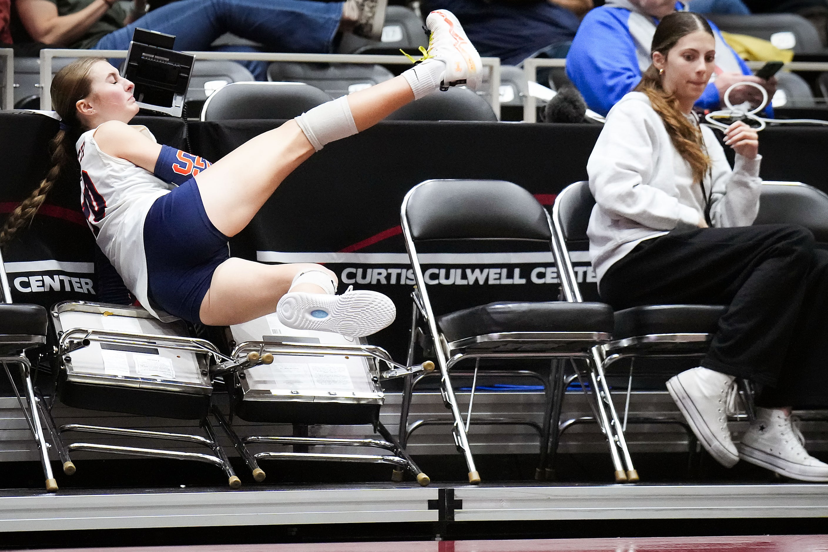 McKinney North's Ellery Langsdale (10) flies into press row chasing a ball during the UIL...