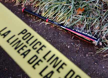 A baseball bat lies inside the crime scene tape after an incident at the Dallas Farmers...