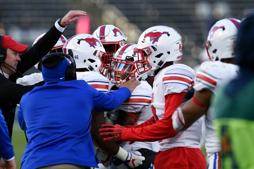 SMU cornerback Kevin Johnson (12) is congratulated after an interception late in the fourth...