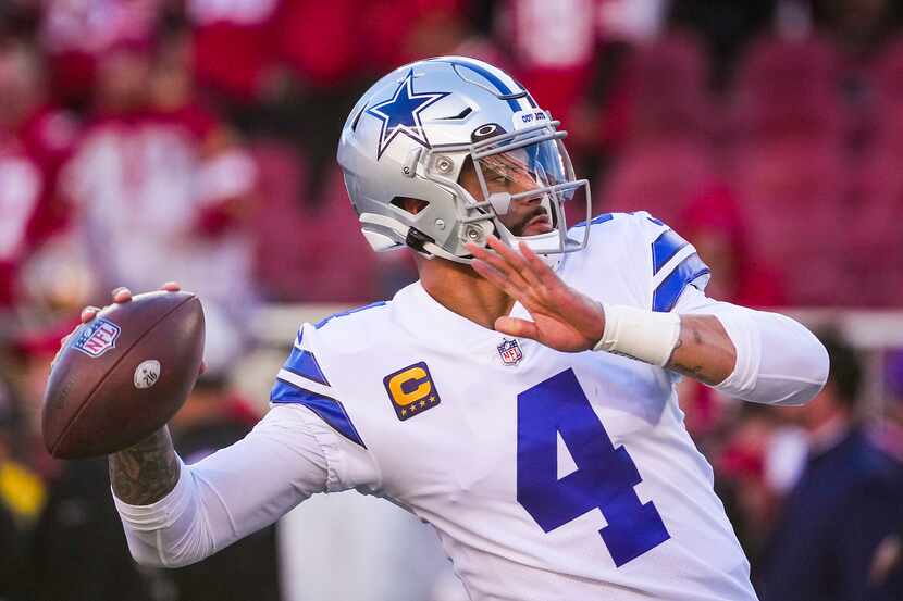 Dallas Cowboys quarterback Dak Prescott (4) warms up before an NFL divisional round playoff...