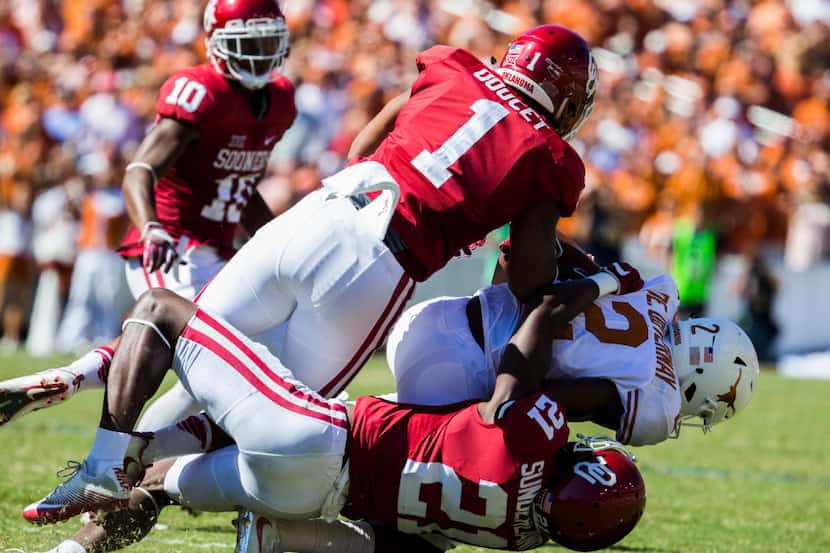 Texas Longhorns wide receiver Devin Duvernay (2) is tackled by Oklahoma Sooners linebacker...