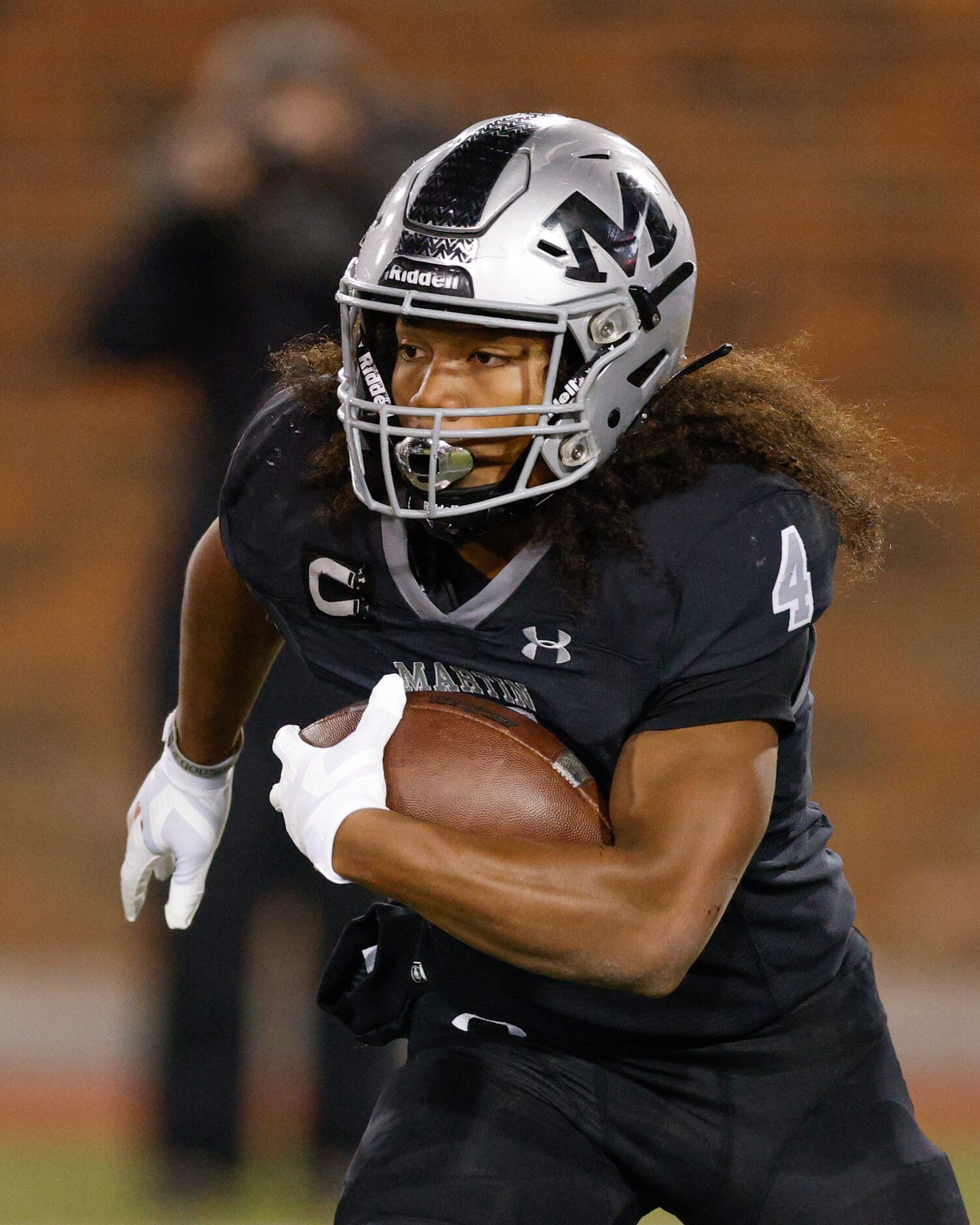 Arlington Martin wide receiver Michael Barrow (4) runs with the ball during the first half...