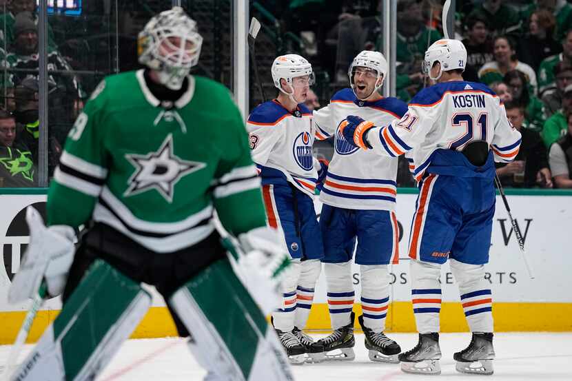 Dallas Stars goaltender Jake Oettinger, left, stands by the net as Edmonton Oilers' Ryan...