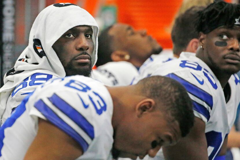Dallas Cowboys wide receiver Dez Bryant (88) is pictured with teammates on the bench in the...
