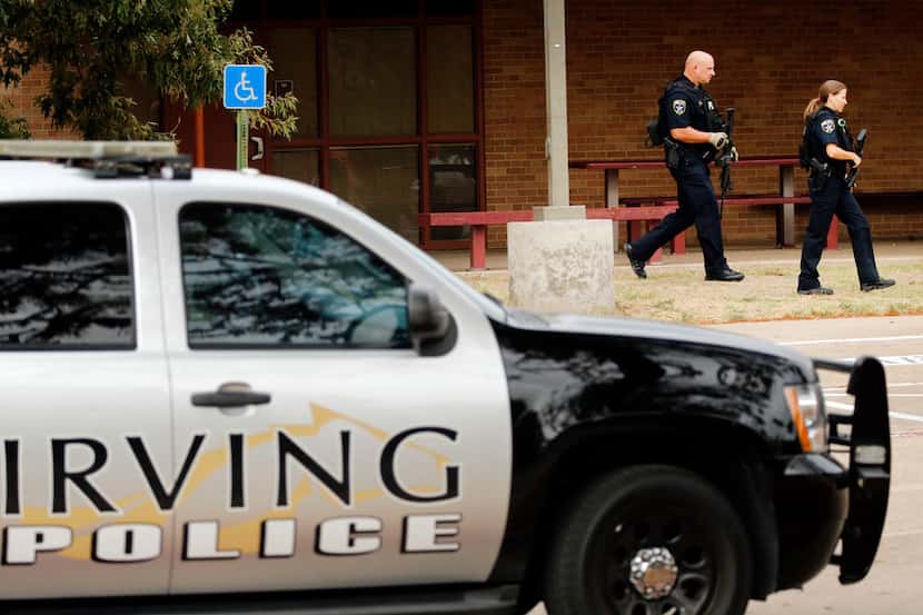 Irving police officers search the Stephen F. Austin Middle School campus in Irving, Texas...