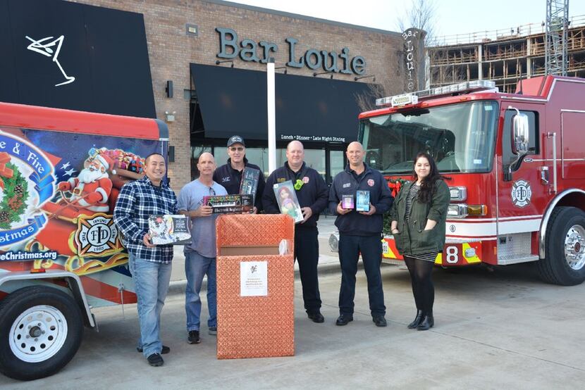 Members of the Irving police and fire departments put on Blue Christmas, a drive for needy...