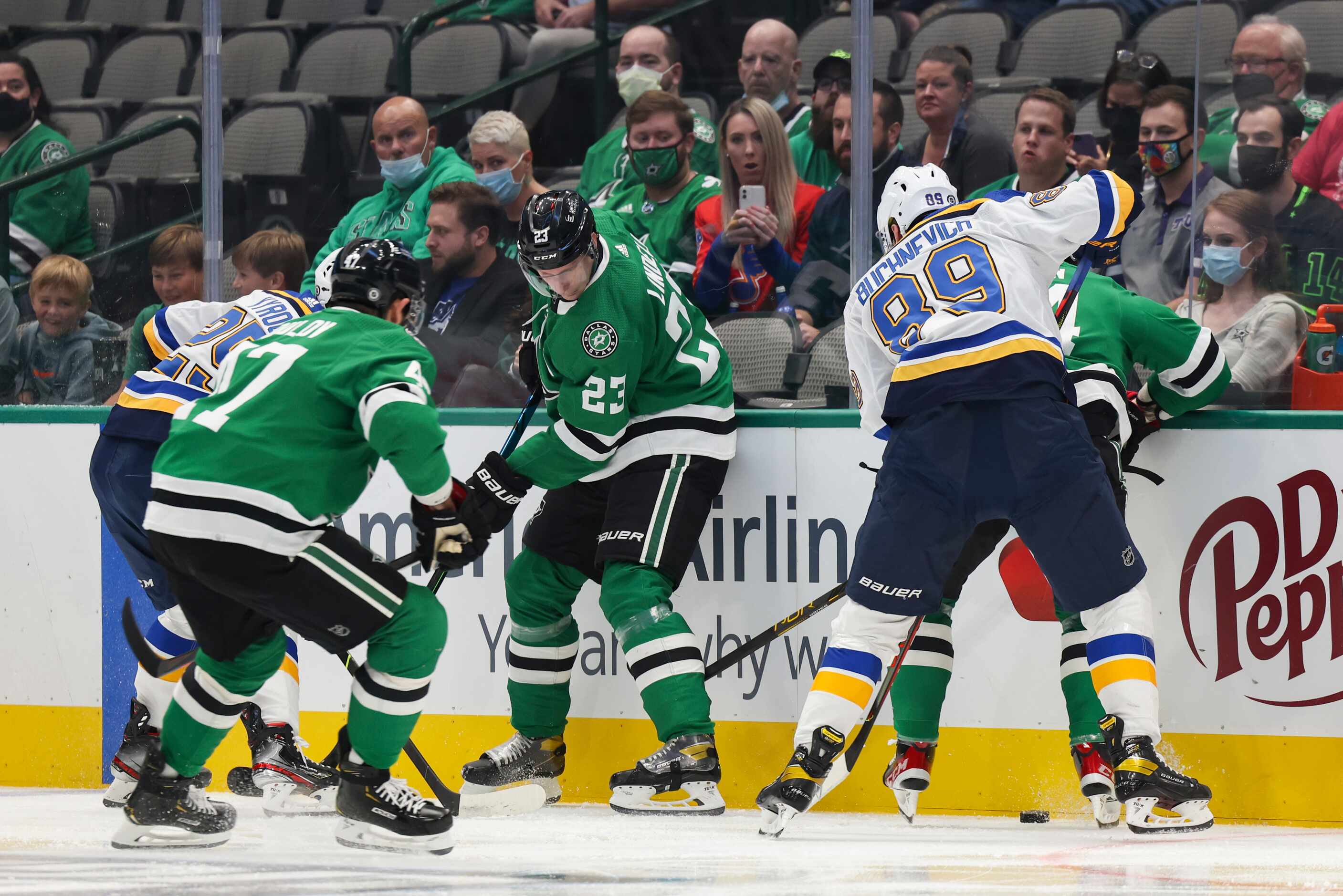 Players fight for the puck during the first period of a Dallas Stars preseason game against...