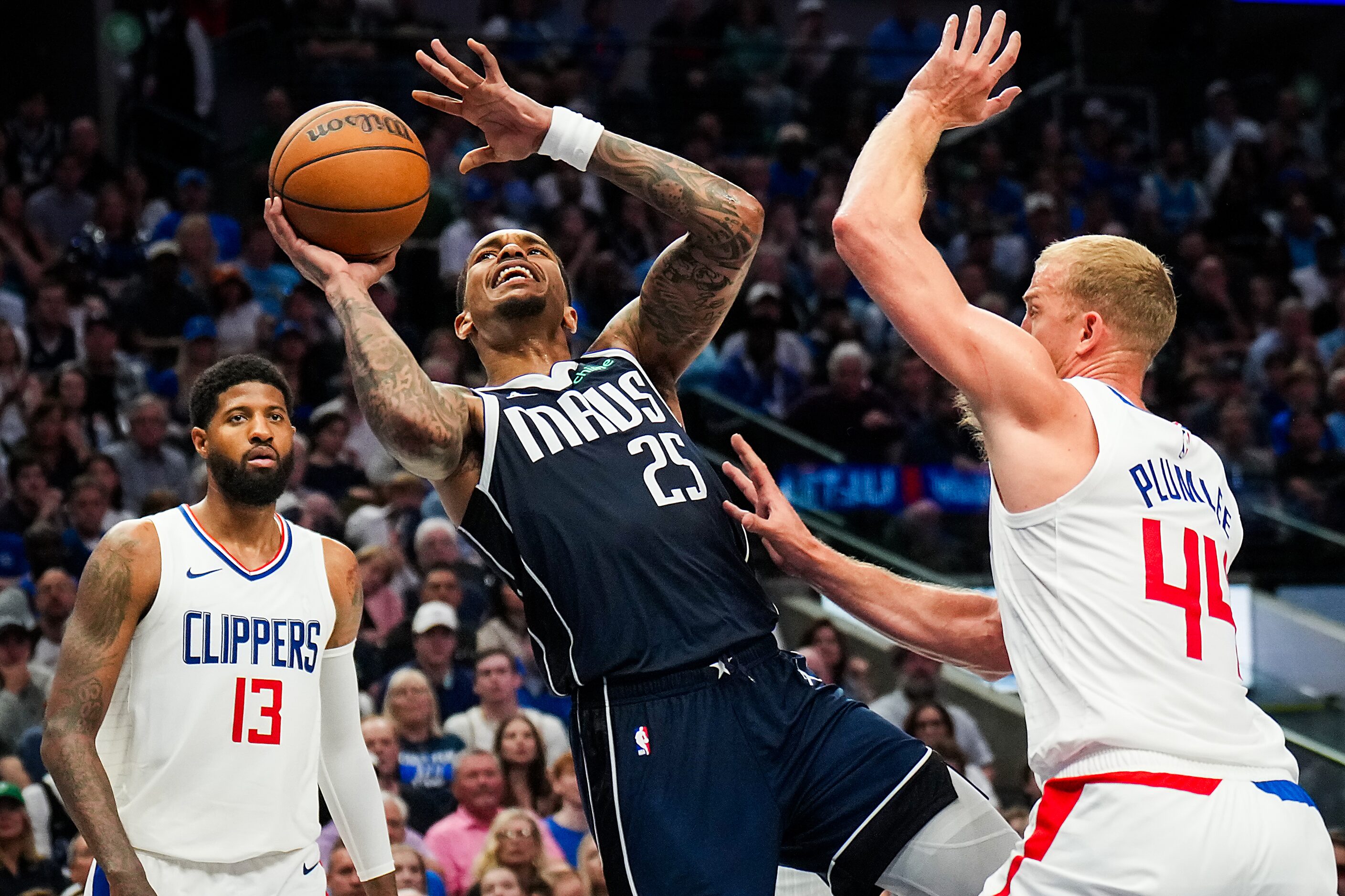 Dallas Mavericks forward P.J. Washington (25) is fouled by LA Clippers center Mason Plumlee...