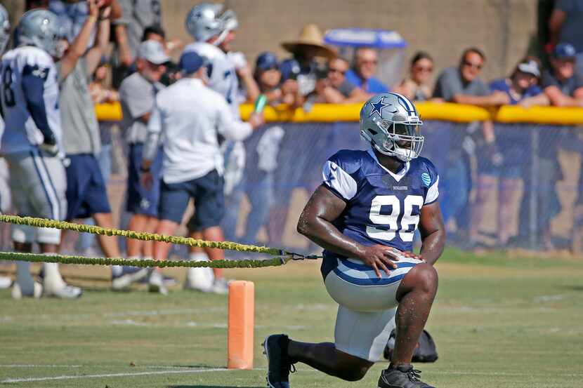 Dallas Cowboys defensive tackle Maliek Collins (96) works out with a resistance cord during...