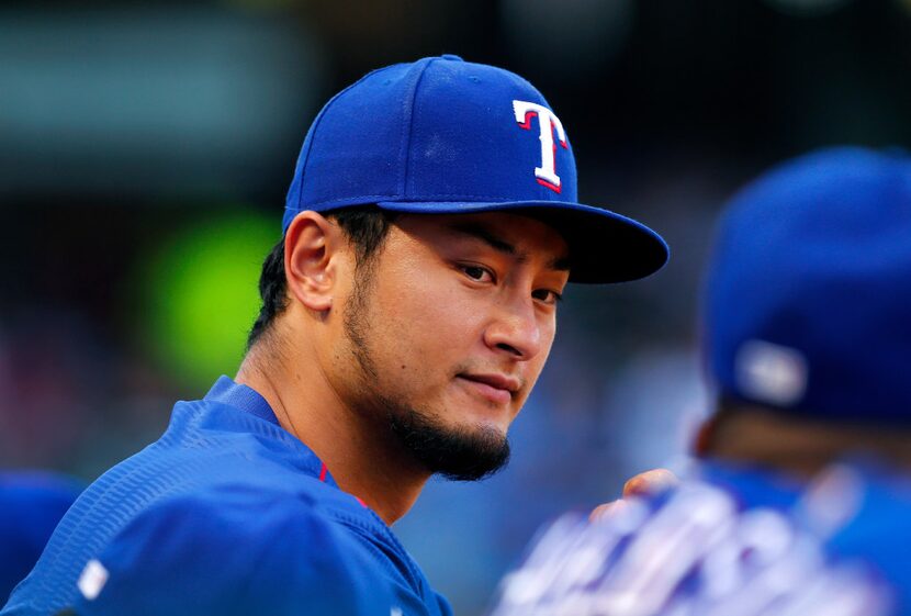 Texas Rangers starting pitcher Yu Darvish watch his teammates face the Miami Marlins at...