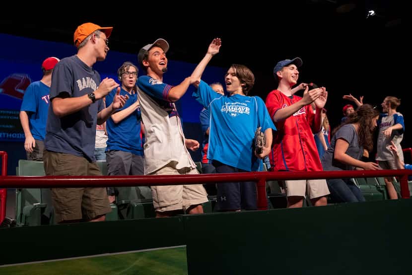 Students reenact the home crowd during the 2011 Rangers versus Red Sox game during dress...