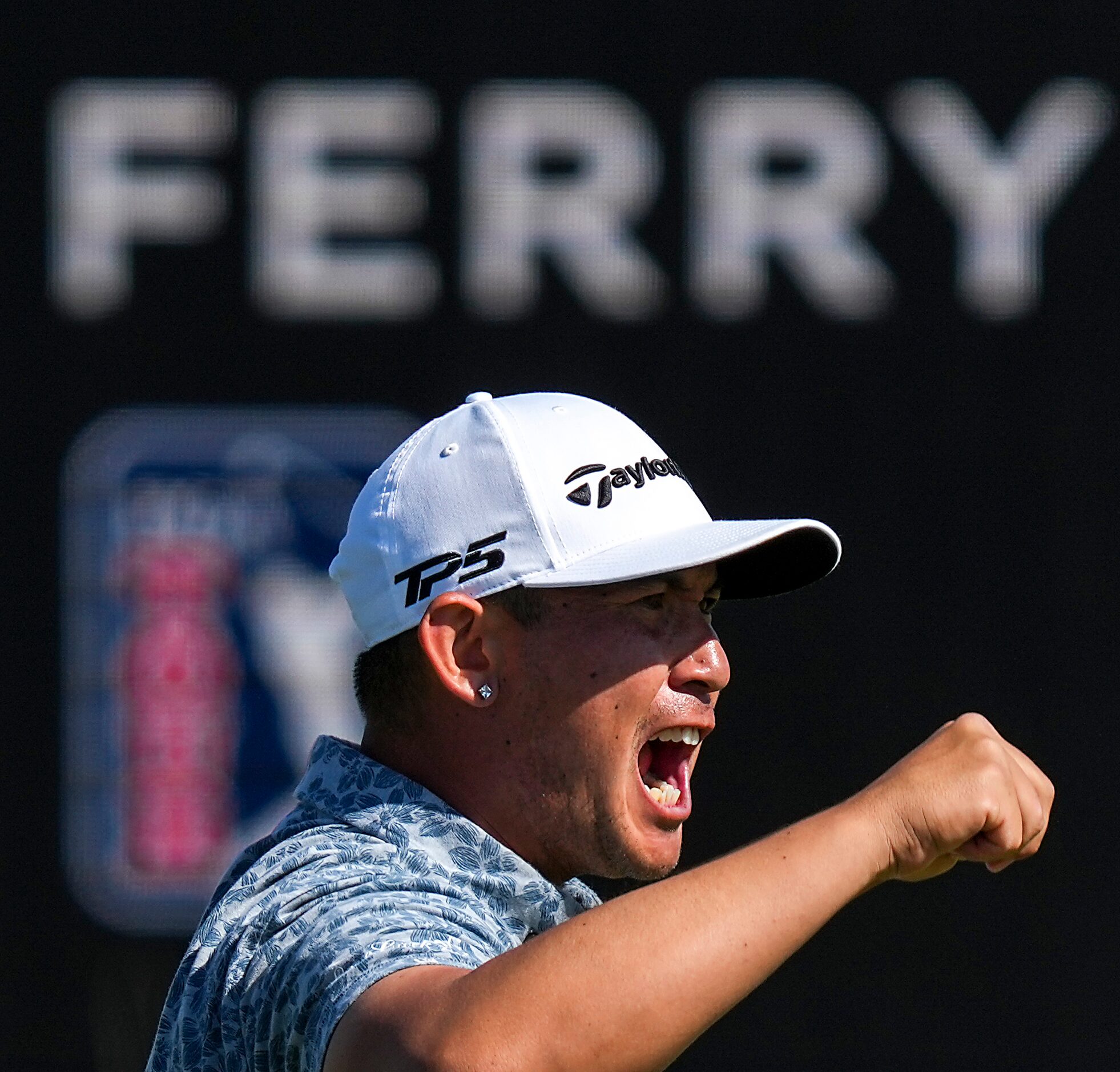 Rico Hoey celebrates after sinking a birdie putt on the 18th hole during the final round of...