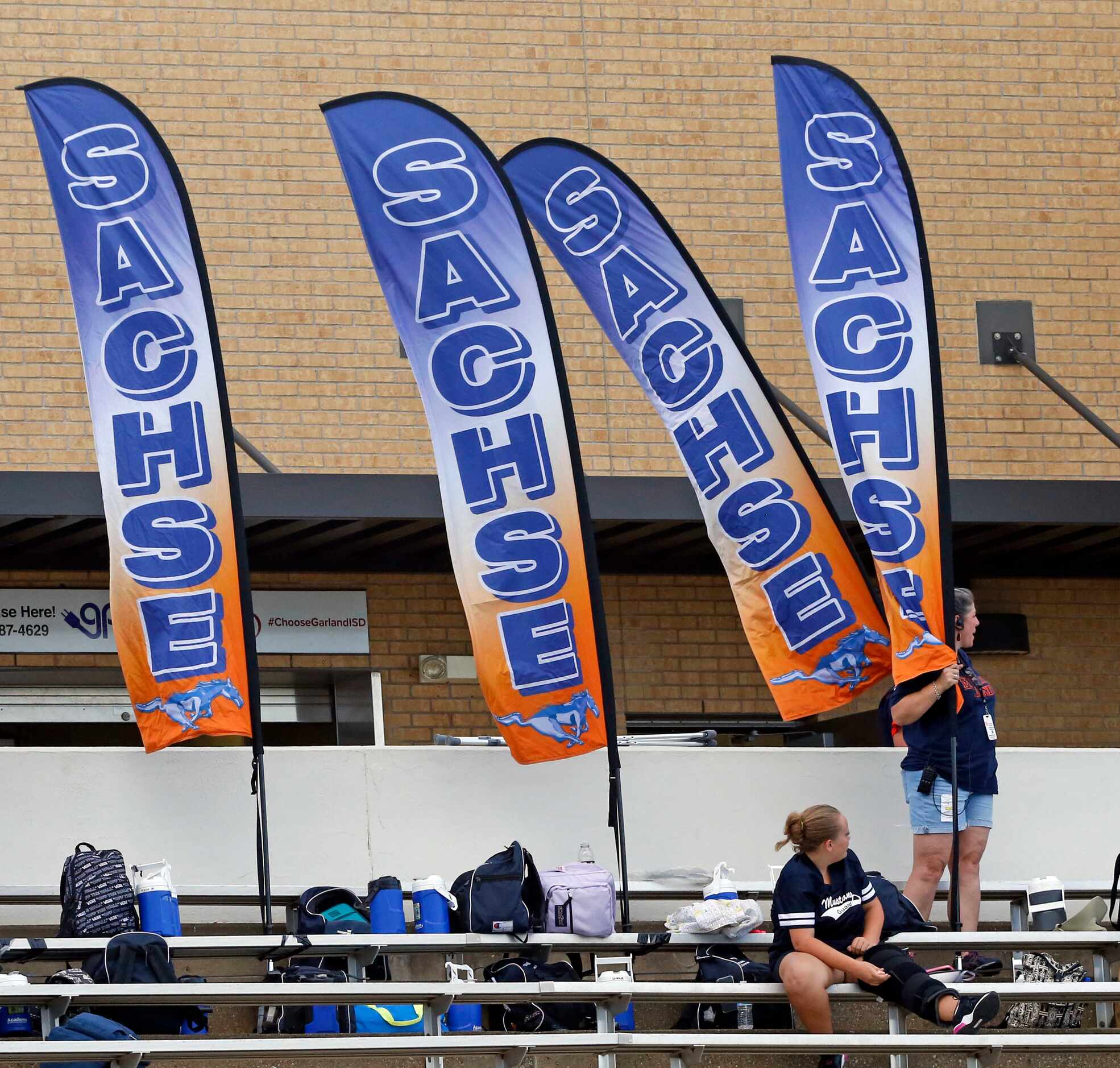 Students hold Sachse banners in the stands during the first half of a high school football...