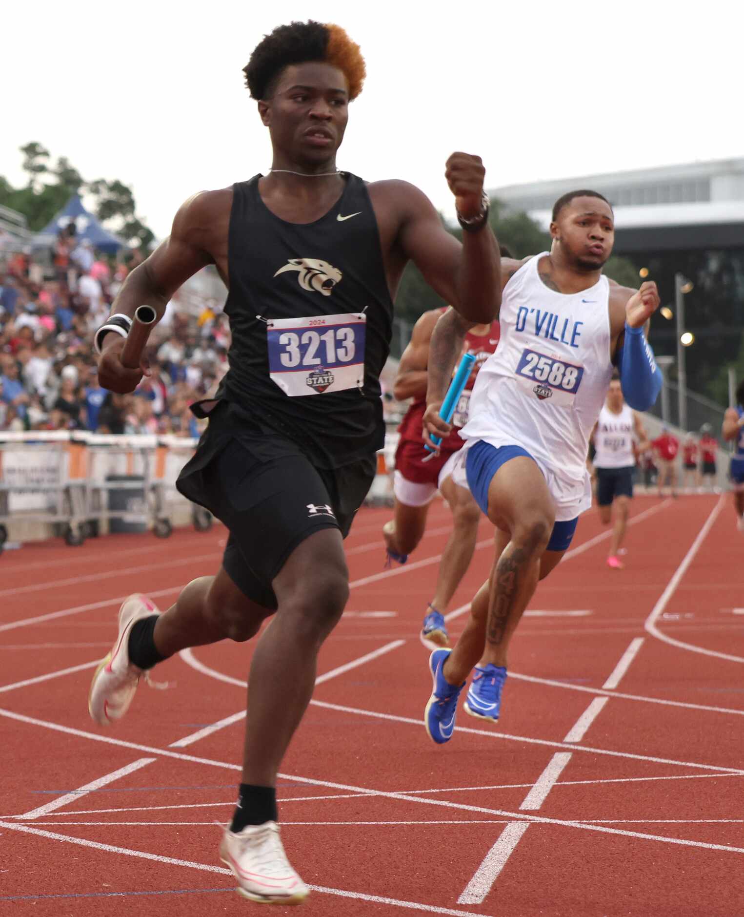 Duncanville's Caden Durham, right, sprints his portion of his school's 6A 4X200 relay...