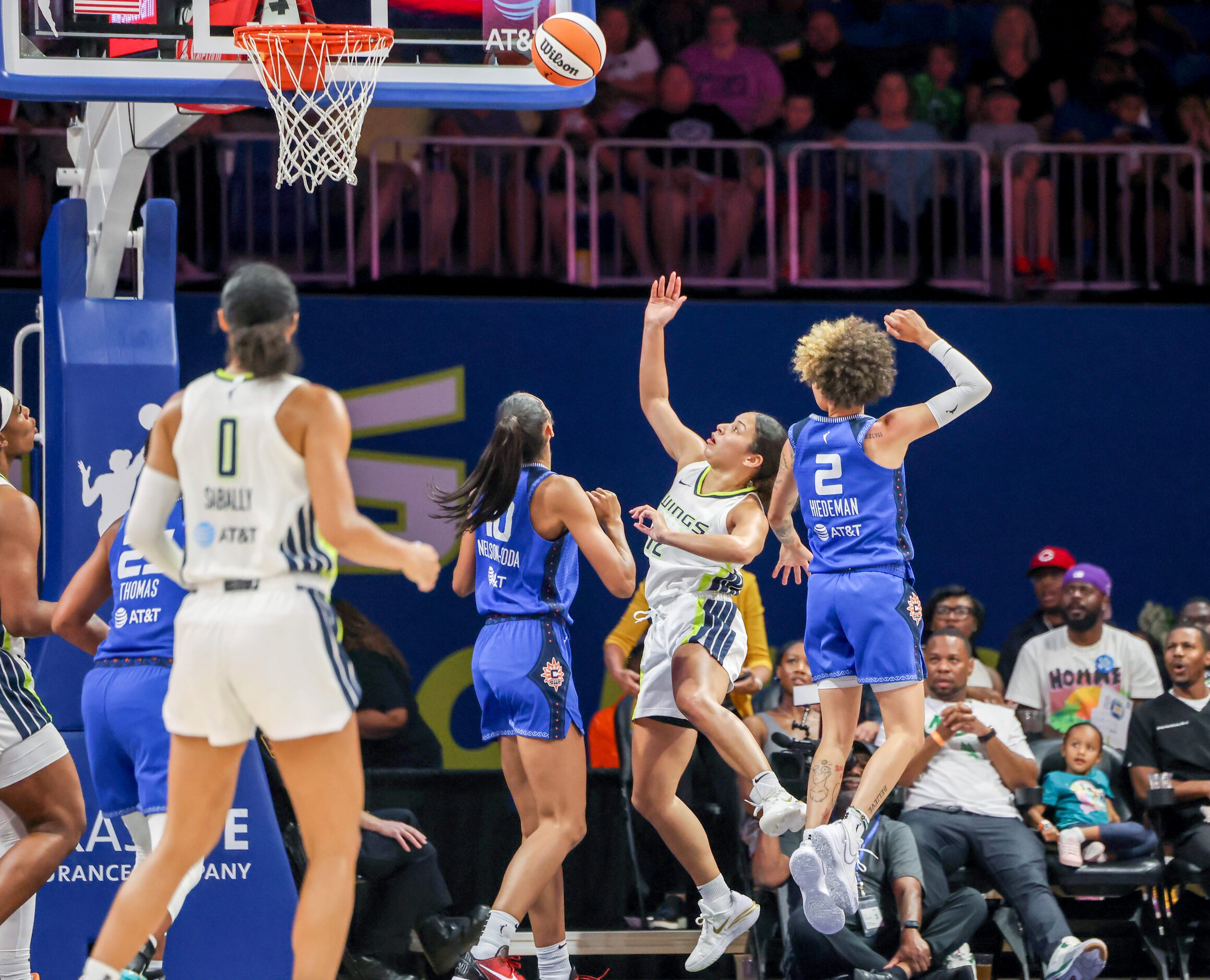 Dallas Wings guard Veronica Burton (12) watches a two-point attempt near the net during a...