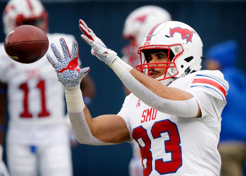 FILE - SMU tight end Kylen Granson (83) catches a pass during pregame warmups before facing...