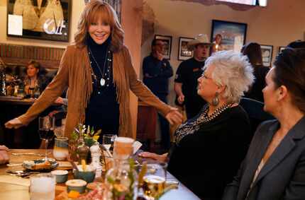 Country music legend Reba McEntire visited with friends during the opening of her new...