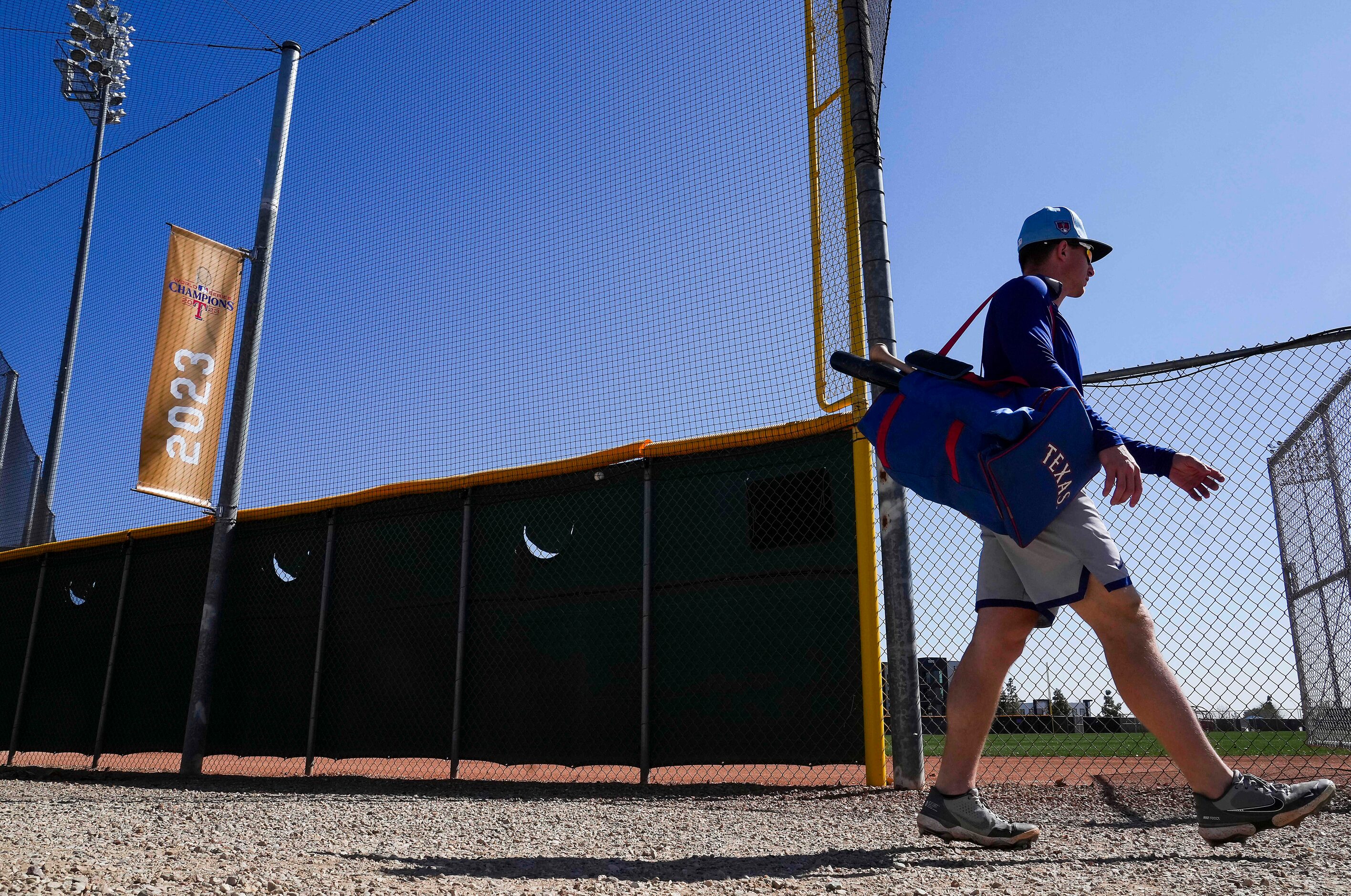 Texas Rangers infielder Justin Foscue passes a banner  banner commemorating the Rangers 2023...