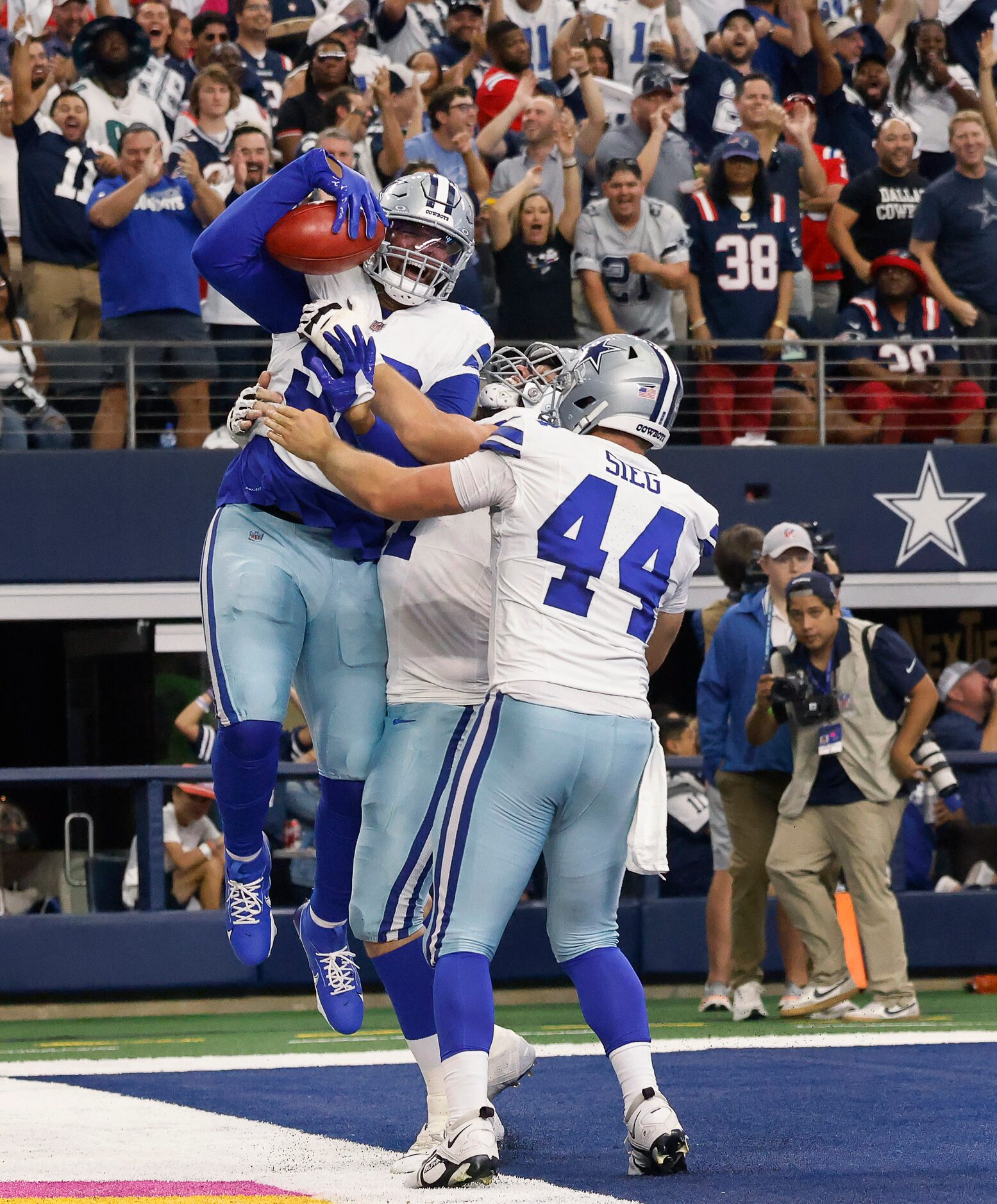 Dallas Cowboys defensive end Chauncey Golston (99) I congratulated by teammates after he...