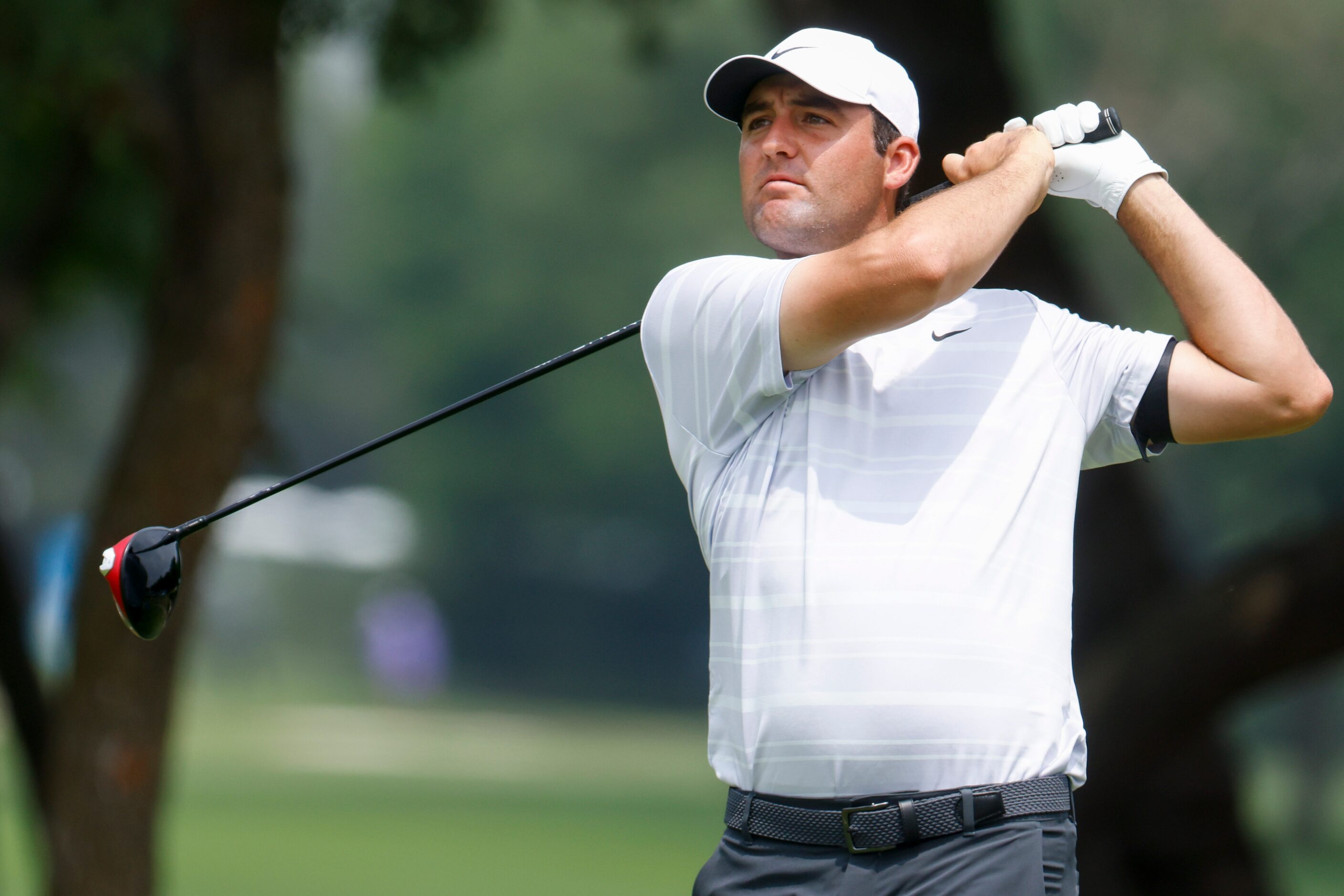 Scottie Scheffler of United States watches as he tees of on the ninth hole during the second...