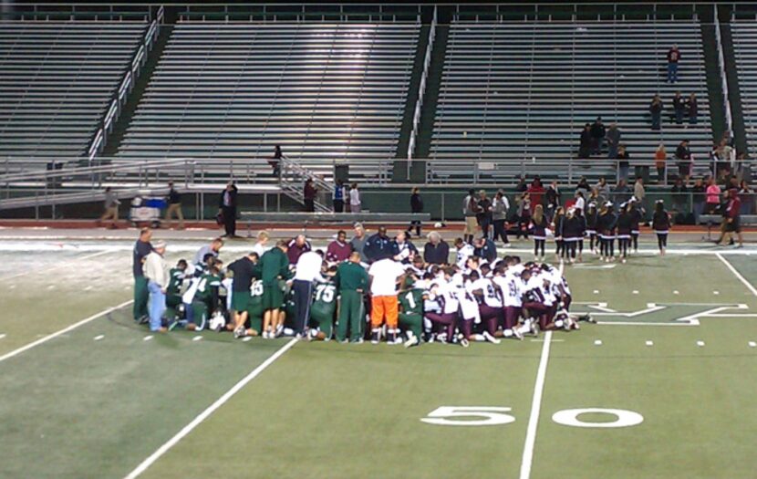 Players from the Waxahachie and Ennis JV teams gathered in prayer after Triston Simpler was...