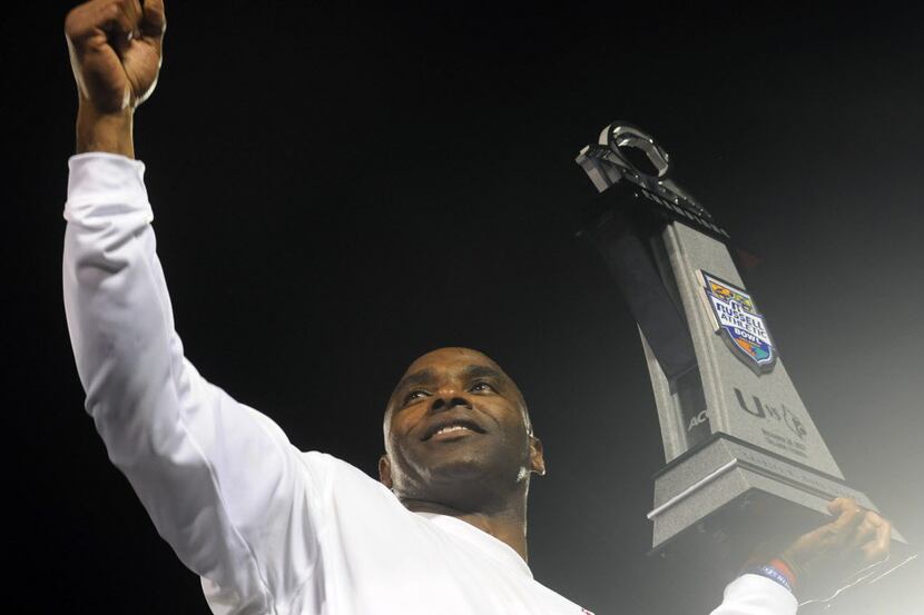 Dec 28, 2013; Orlando, FL, USA; Louisville Cardinals head coach Charlie Strong holds the...