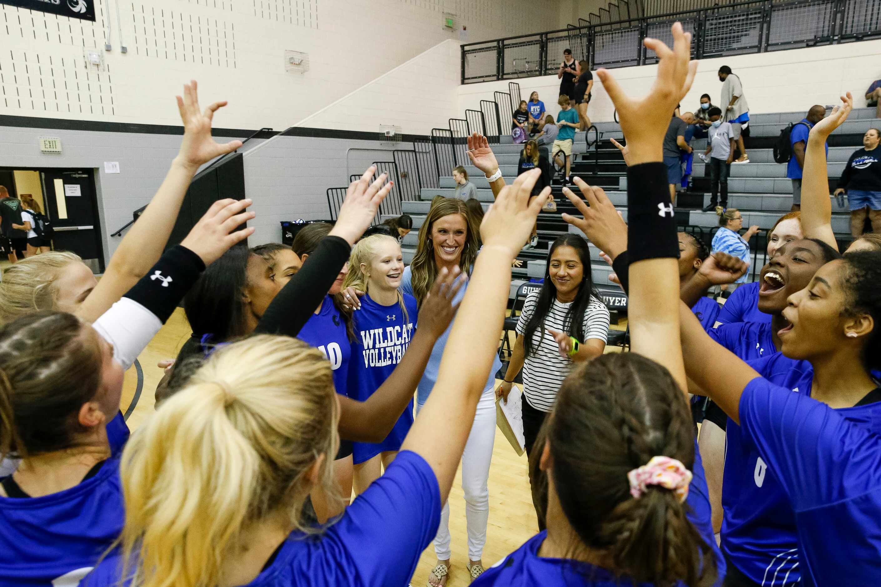 Denton Guyer head coach Leslie Jackson (center left) celebrates a win with her team over...