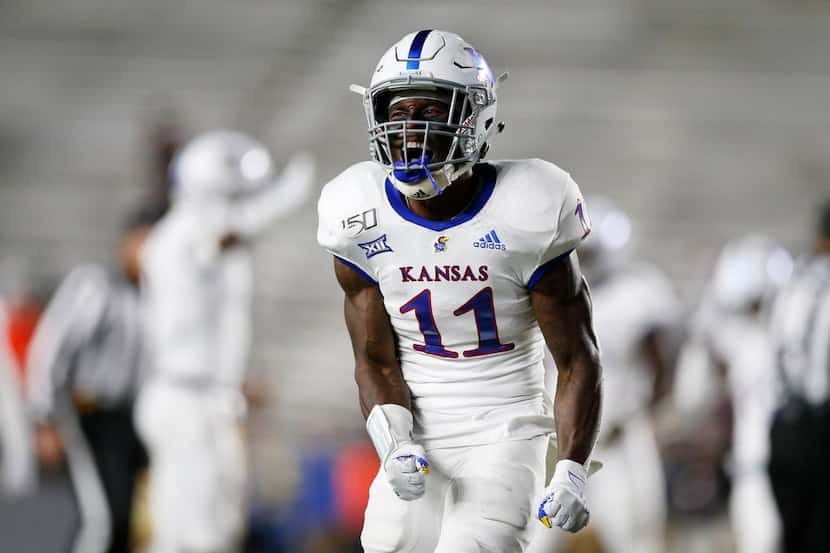 Kansas safety Mike Lee reacts during the second half of an NCAA college football game...