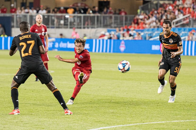 Toronto FC forward Tsubasa Endoh (31) shoots through the Houston Dynamo defense during...