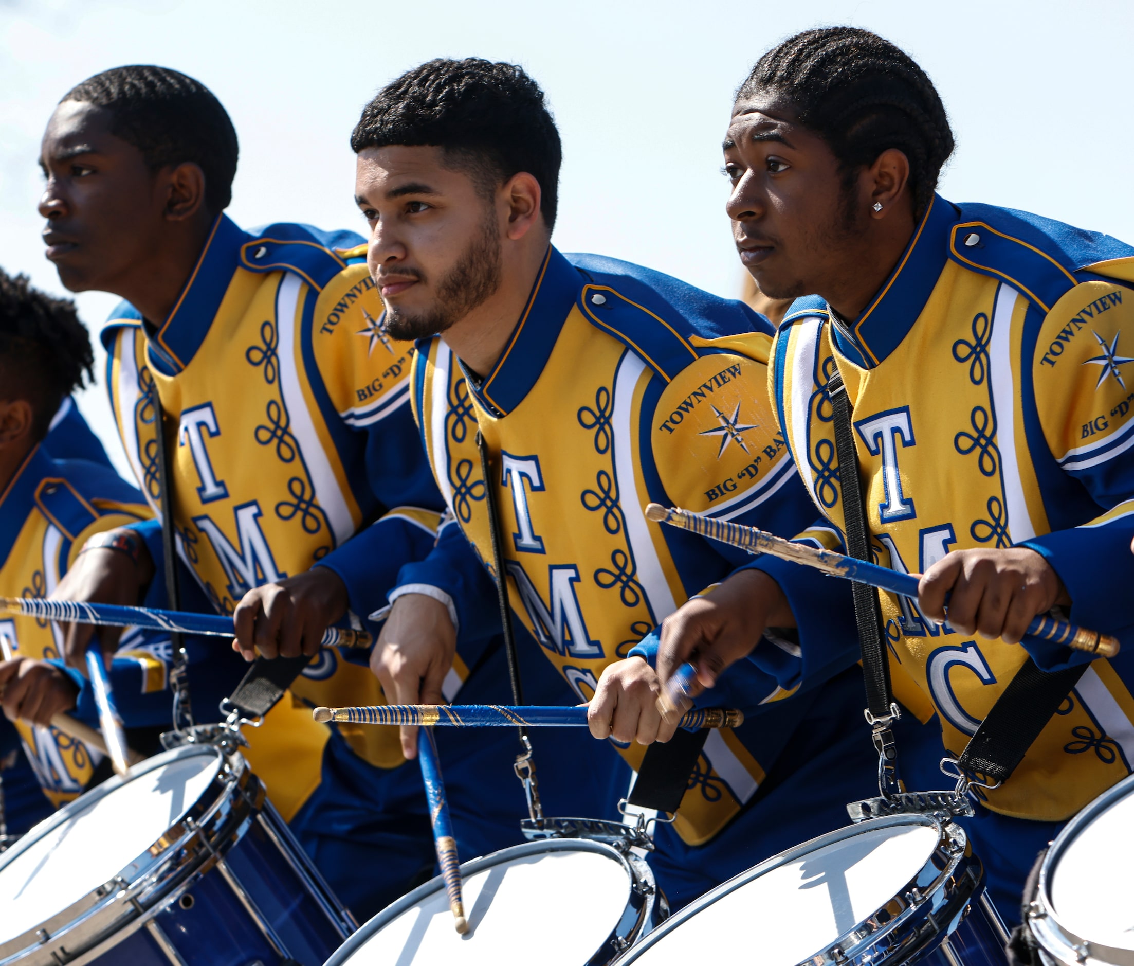 Asten Nolan, 15, Valentin Hernandez, 17 and DeMarion Hughs, 17 tap their snares in a cadence...