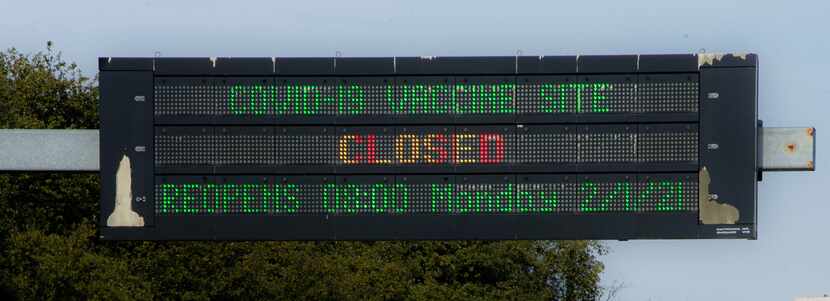 A sign outside of Fair Park announcing the COVID-19 vaccine site reopens Monday in Dallas on...