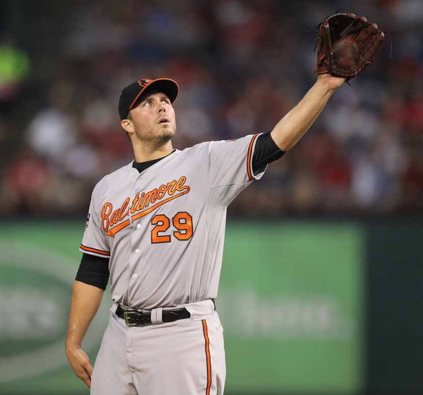 Baltimore starter Tommy Hunter gets a new ball after giving up the second of three home runs...