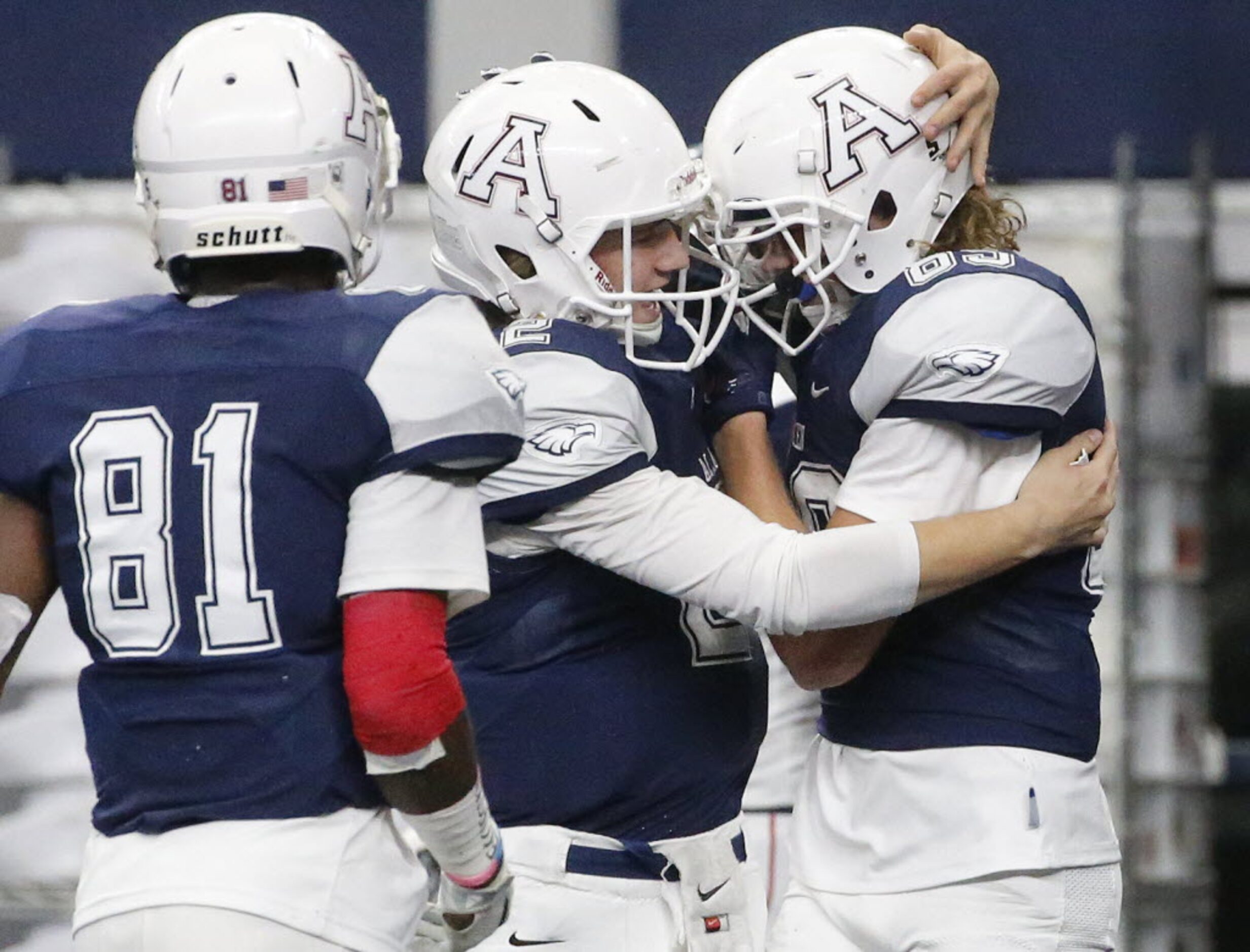 Allen quarterback Mitchell Jonke (2) hugs receiver Camden Harrison (right) after a touchdown...