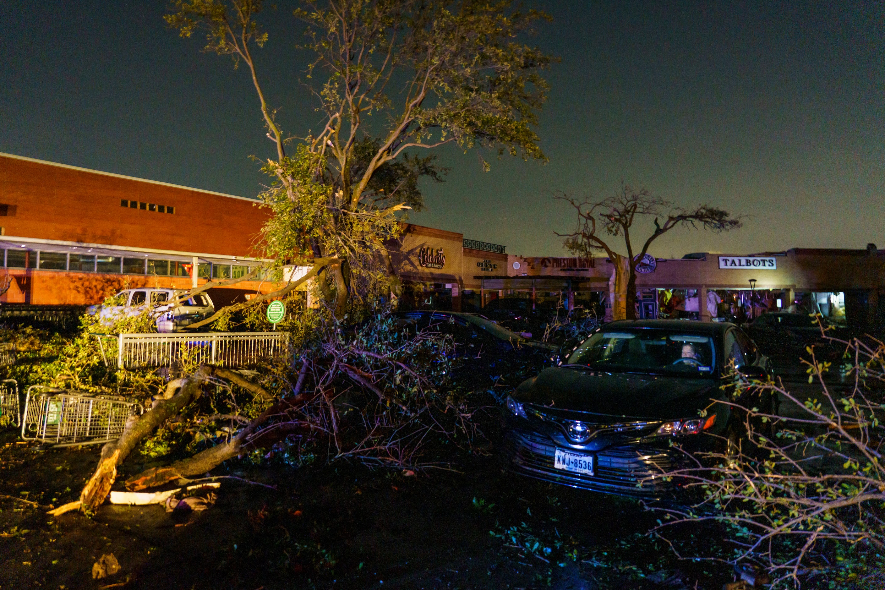 A woman sits in a car surrounded by tornado damage near the intersection of Royal and...